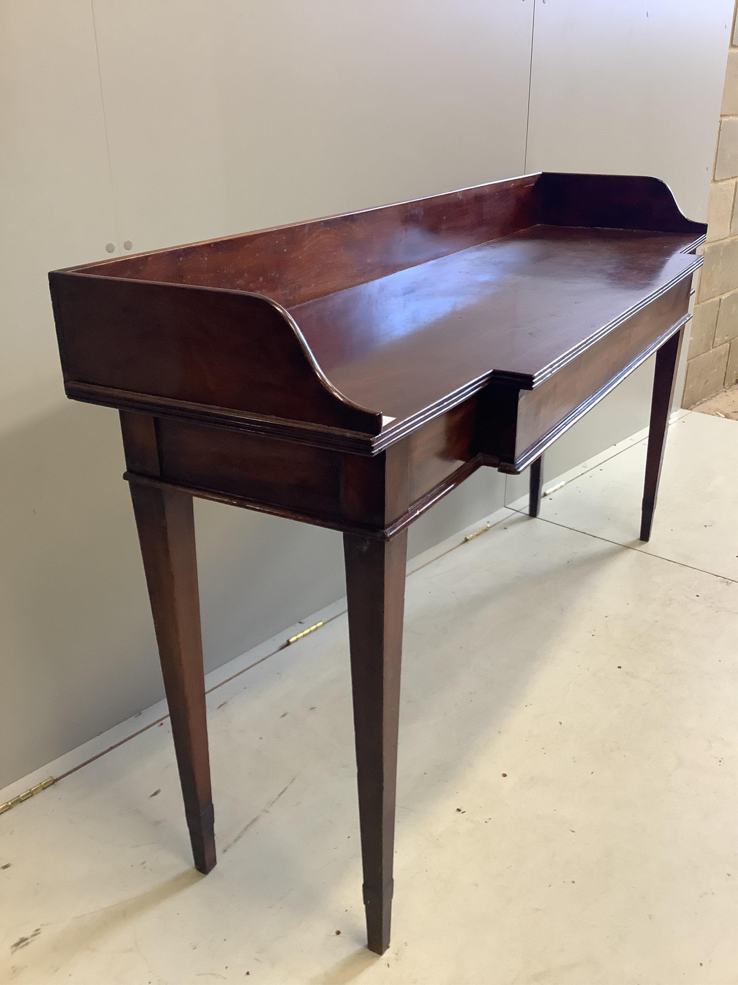 A George III mahogany breakfront serving table, with a three quarter galleried top, width 162cm, depth 48cm, height 93cm. Condition - fair